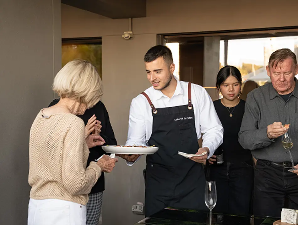 Waiter offering canapés to guests at a fully managed Campbelltown event