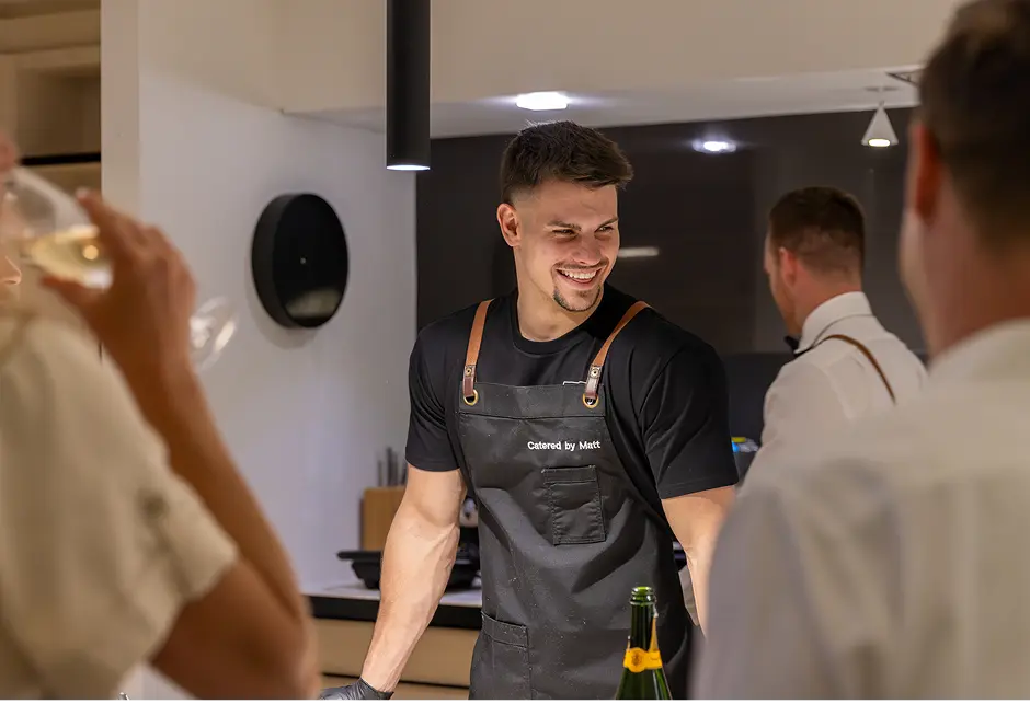 Chef opening sparkling wine for guests at a Campbelltown celebration