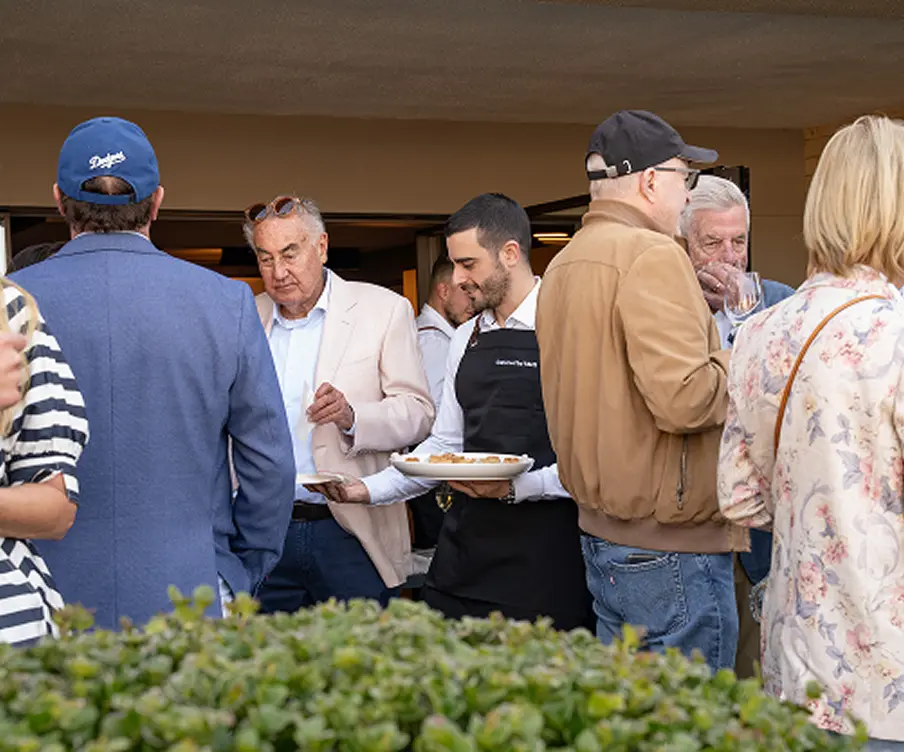 Waiter serving canapés to guests at an outdoor Campbelltown celebration