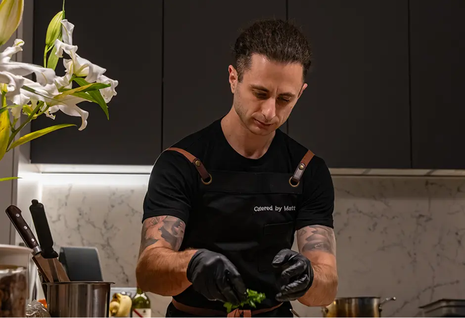 Chef plating a dish in a Campbelltown kitchen during event service