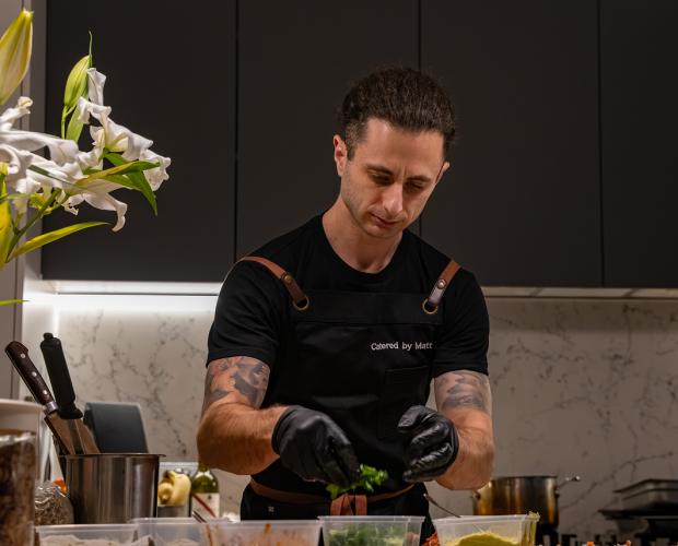 Chef Vinnie focused on finishing bridal shower catering plates with precision